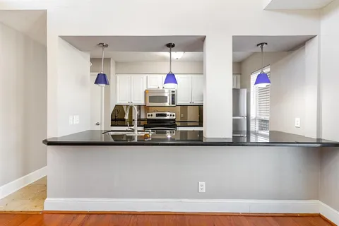 a kitchen with a sink and a refrigerator