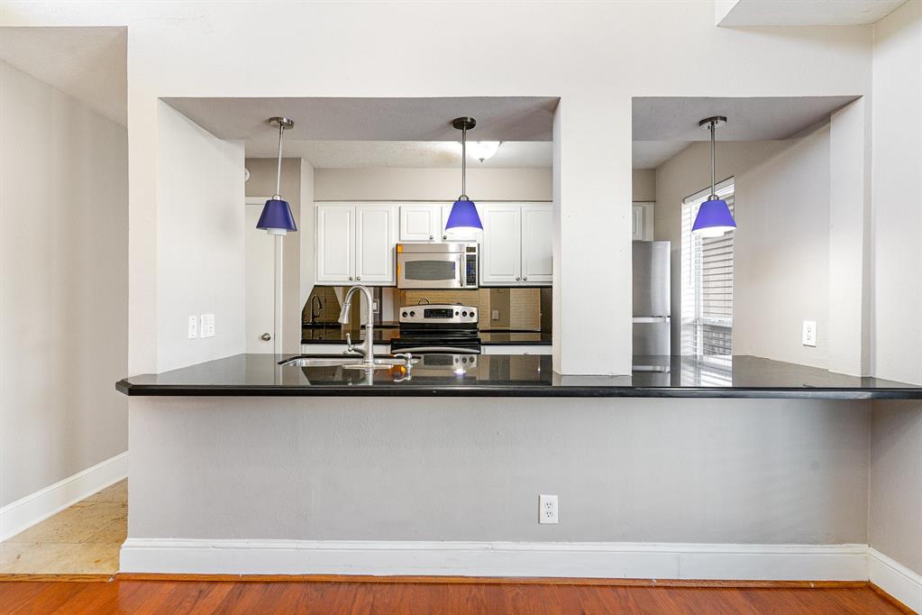5934 Sandhurst Lane, Unit 207 Dallas, TX 75206 - Photo 6 of 31 a kitchen with a sink and a refrigerator