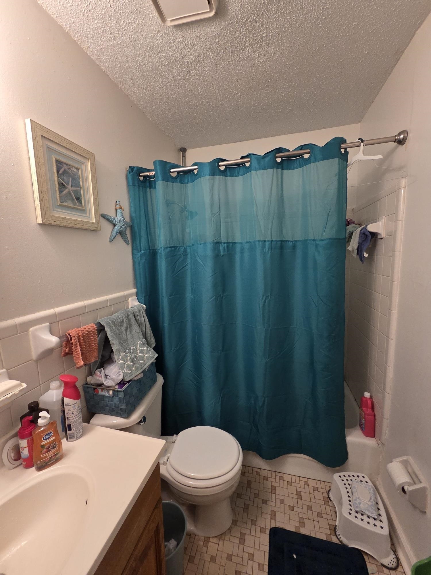 899 West Raines Road Memphis, TN 38109 - Photo 6 of 10 Bathroom featuring a white toilet, built-in bathtub, and a single vanity with wood-finish cabinetry