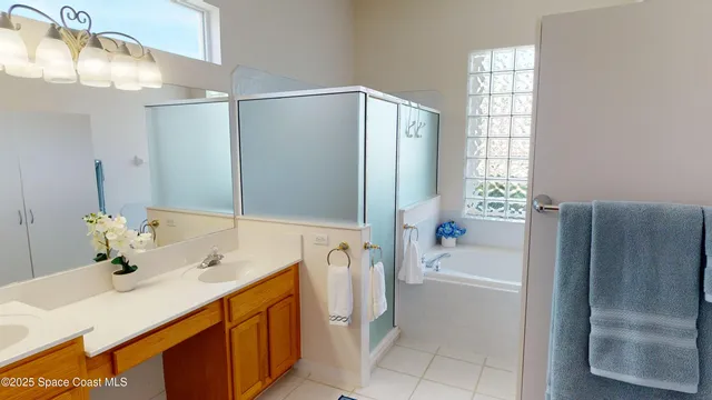 a bathroom with a tub sink and mirror