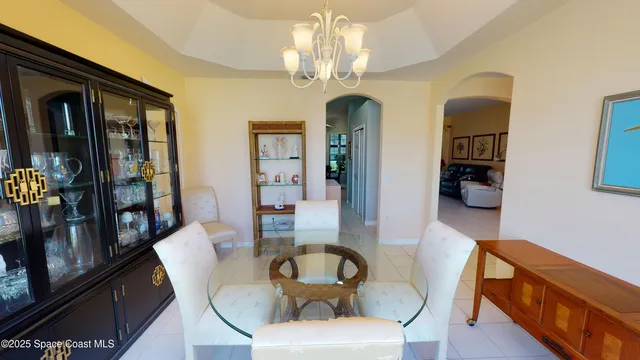 a living room with furniture and chandelier