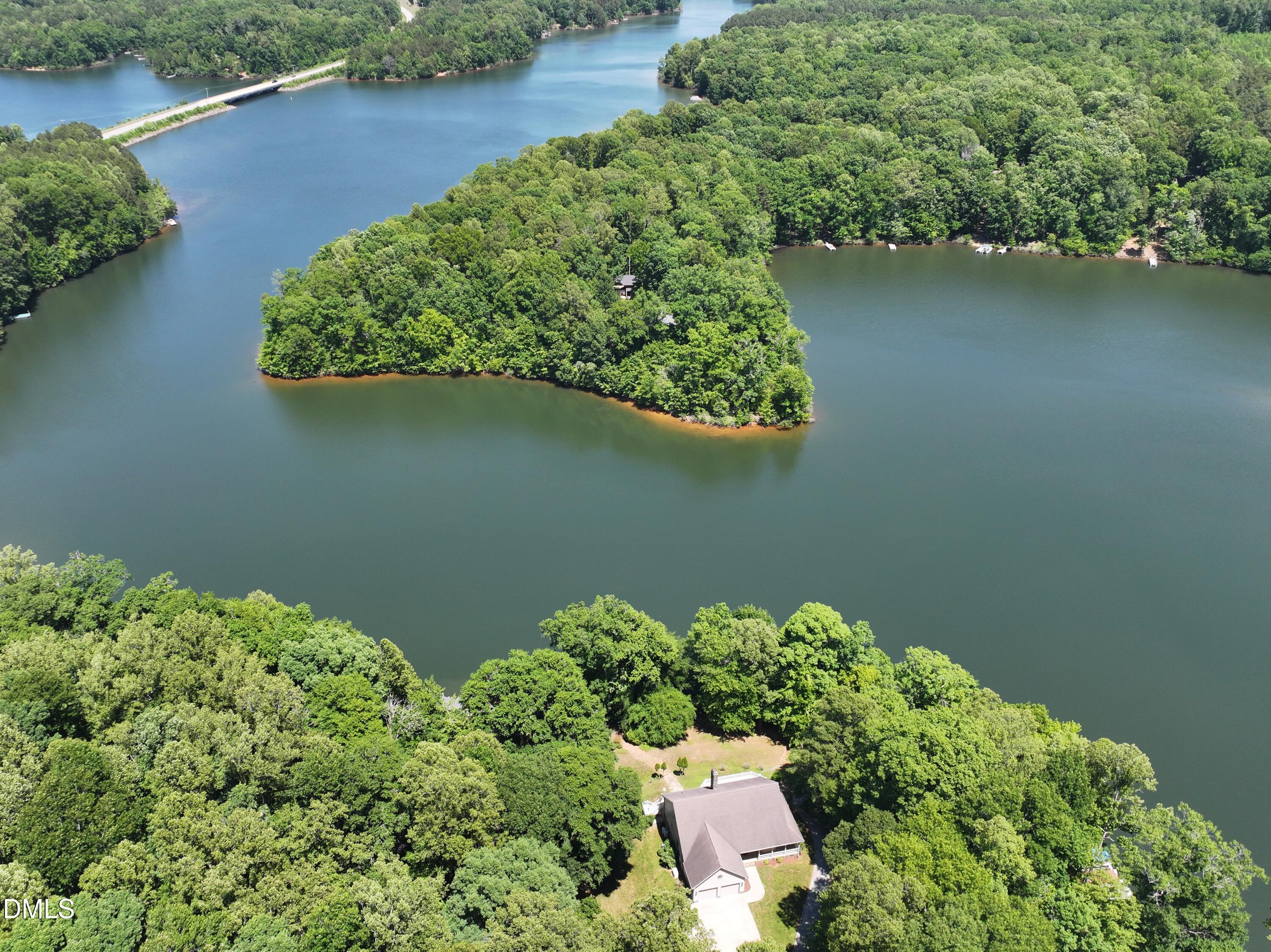 81 Beaver Crossing Road Roxboro, NC 27574 - Photo 71 of 80 an aerial view of a house with a yard and lake view