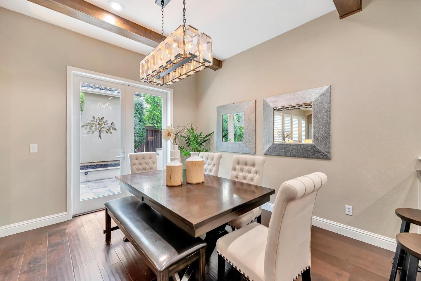 2160 Gullane Way Gilroy, CA 95020 - Photo 12 of 40 a view of a dining room with furniture a chandelier and wooden floor