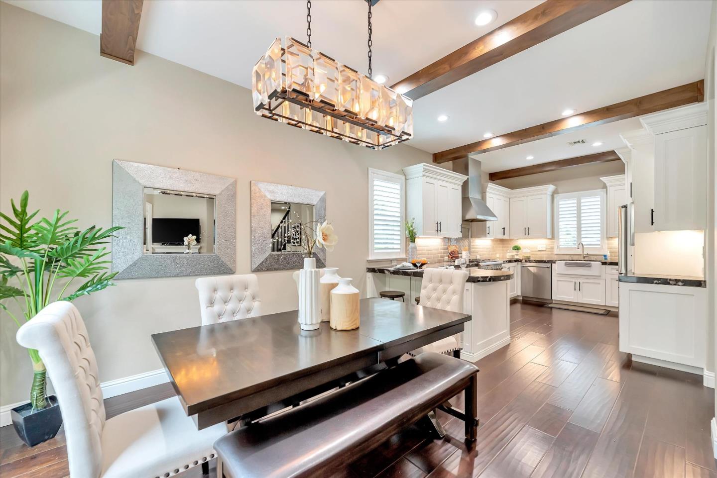 2160 Gullane Way Gilroy, CA 95020 - Photo 13 of 40 a view of a dining room with furniture a chandelier and wooden floor