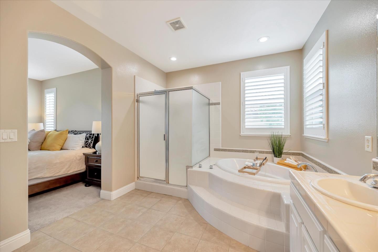 2160 Gullane Way Gilroy, CA 95020 - Photo 26 of 40 a bathroom with a double vanity sink tub and a large mirror