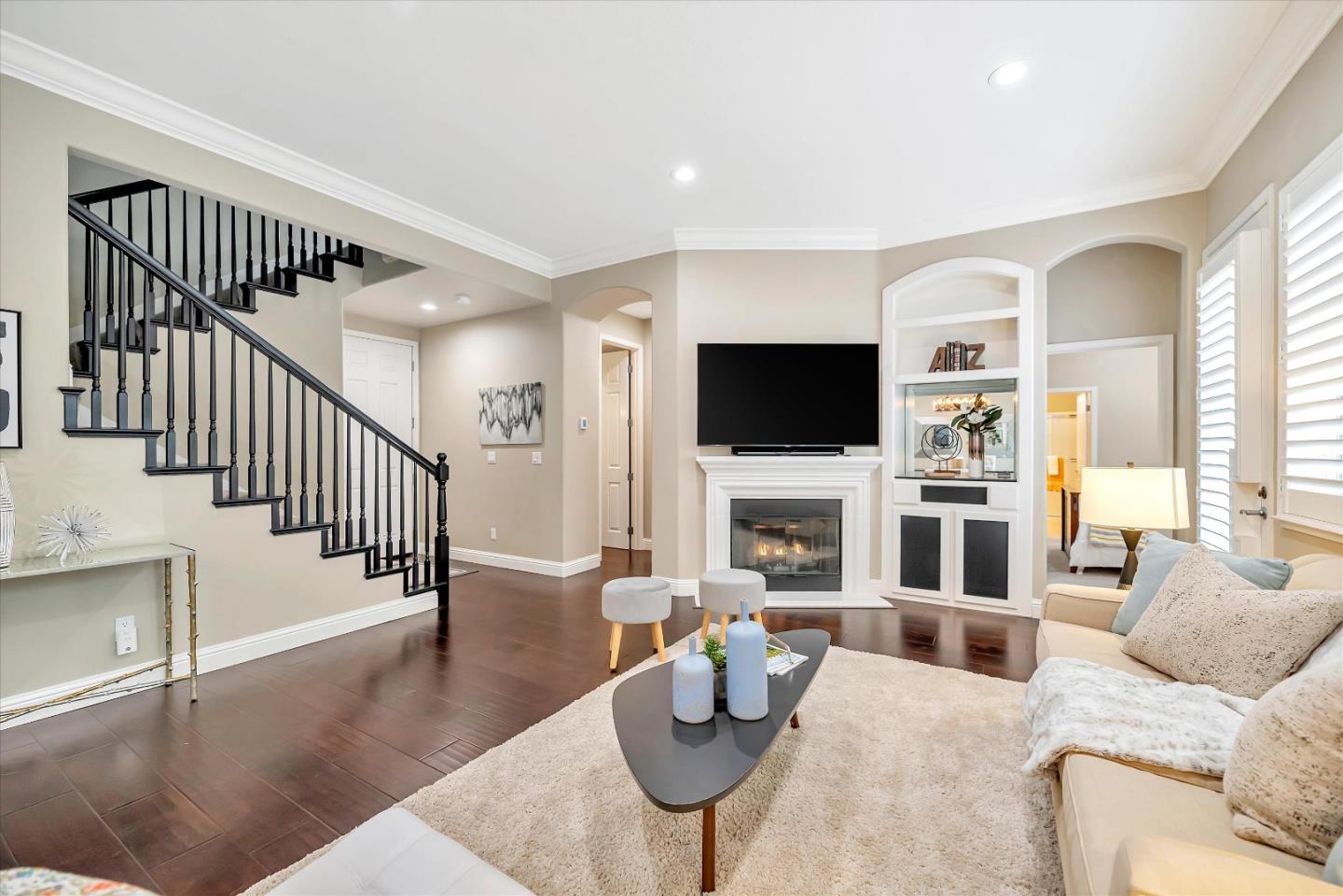 2160 Gullane Way Gilroy, CA 95020 - Photo 4 of 40 a living room with furniture a fireplace and a flat screen tv