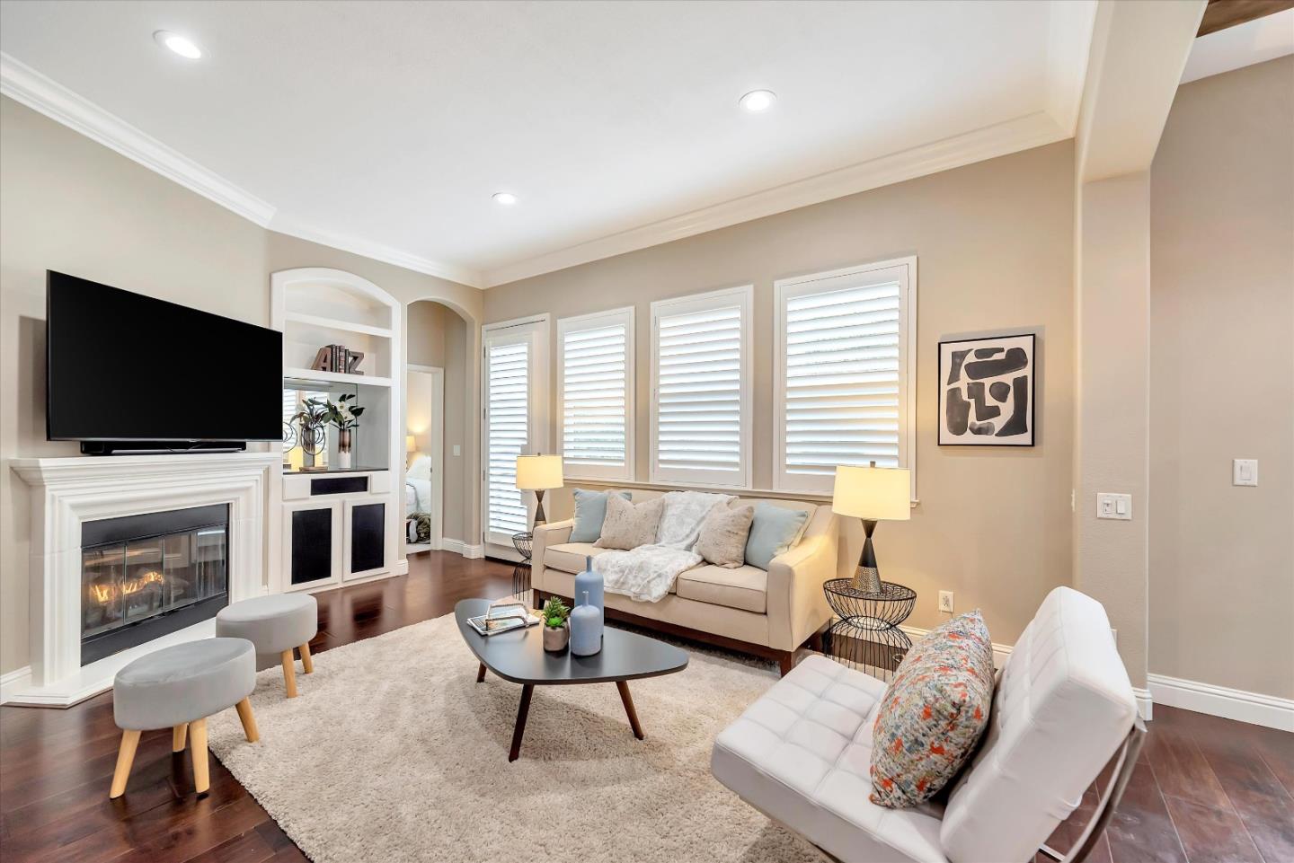 2160 Gullane Way Gilroy, CA 95020 - Photo 6 of 40 a living room with furniture a flat screen tv and a fireplace