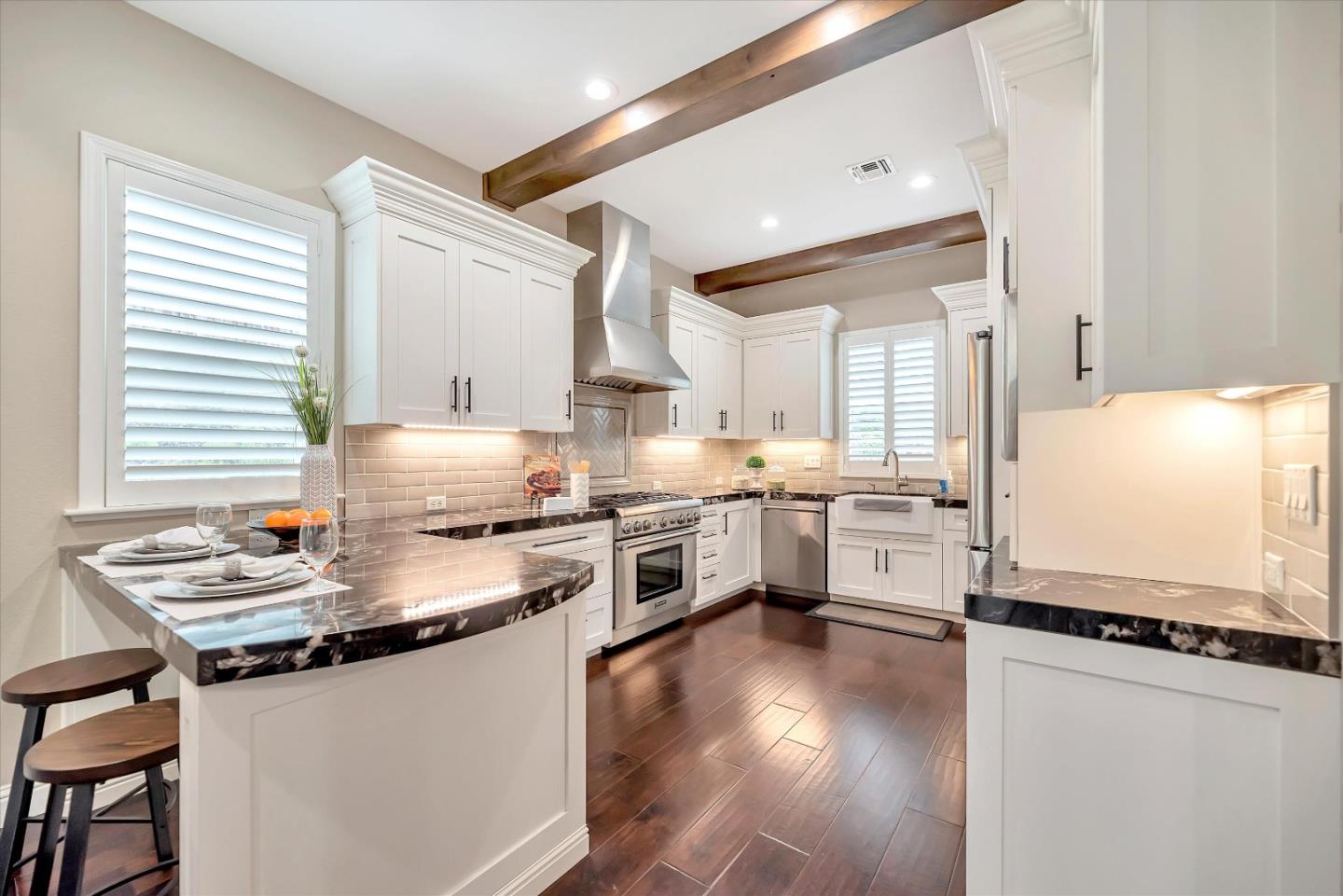2160 Gullane Way Gilroy, CA 95020 - Photo 8 of 40 a kitchen with stainless steel appliances a stove a sink dishwasher a refrigerator and white cabinets with wooden floor