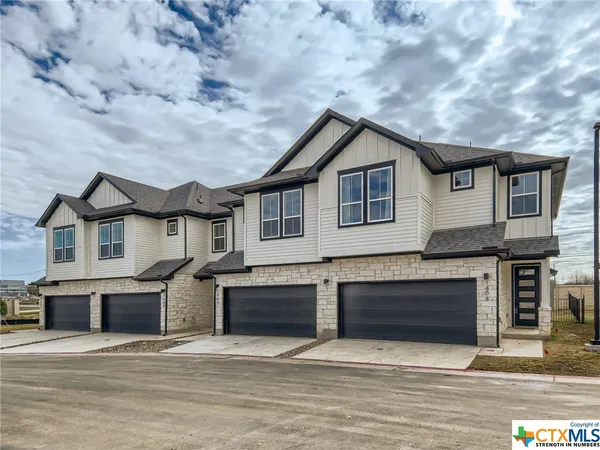 a front view of a house with yard and garage