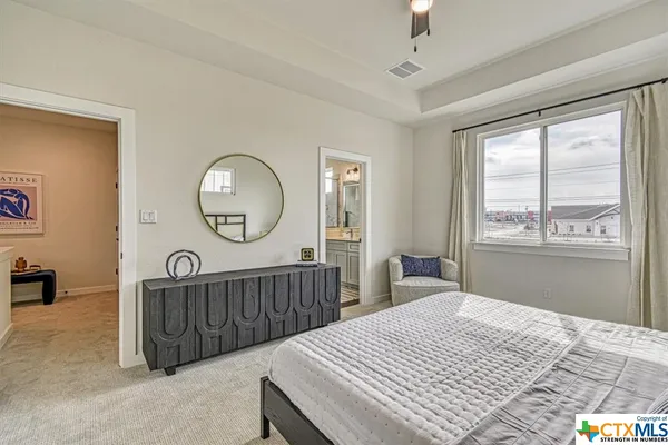 a bedroom with a large bed and a window