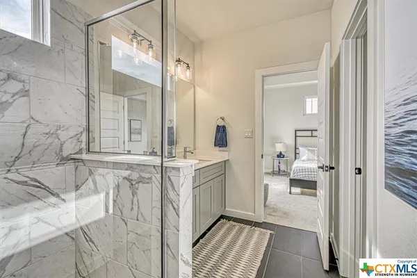 a bathroom with double vanity sink and a mirror