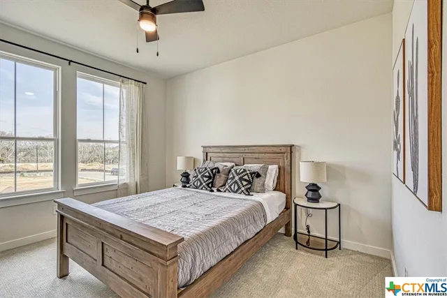 a bedroom with a large bed and a chandelier