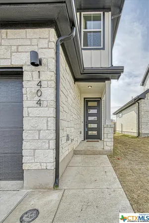 a view of front door of house with stairs