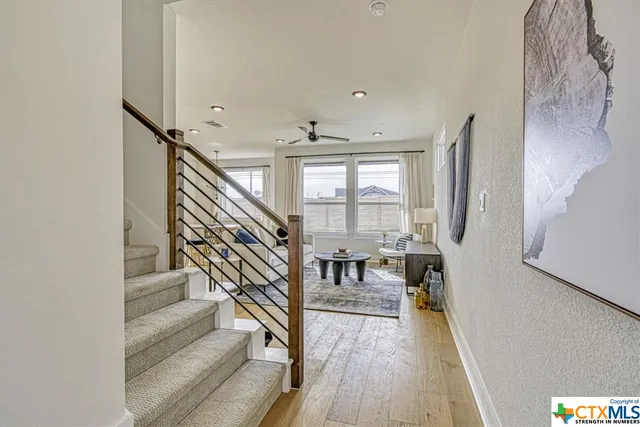 a view of entryway and hall with wooden floor