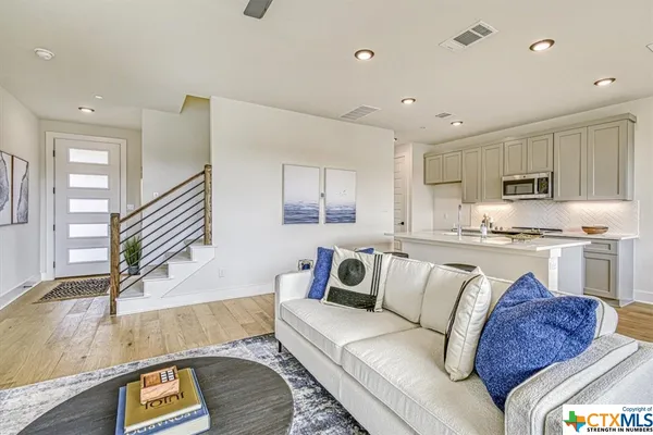 a living room with kitchen and a couch