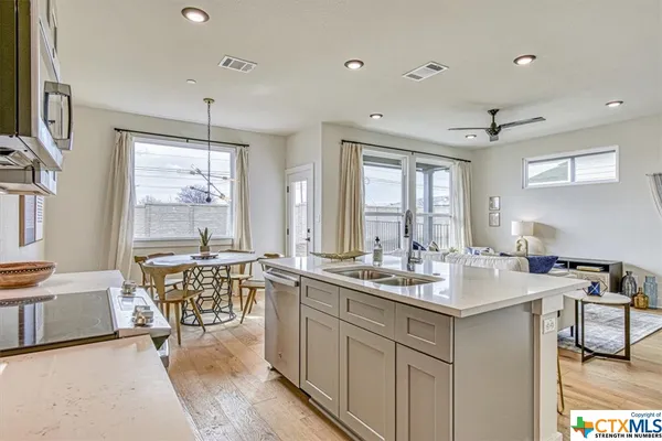 a kitchen with a table chairs stove and cabinets