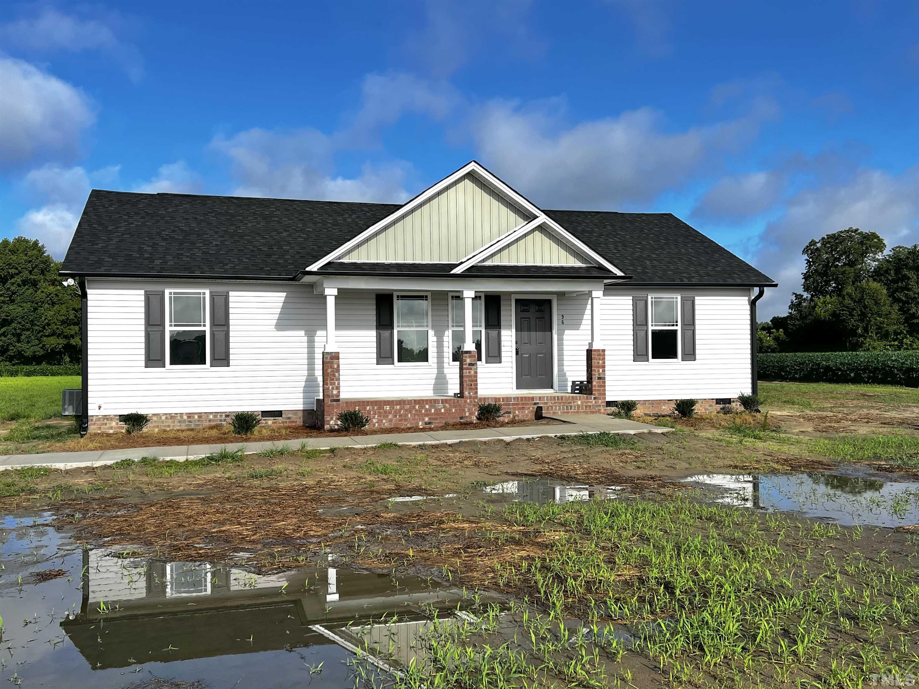 96 Mamie Road Benson, NC 27504 - Photo 1 of 20 a view of a house with backyard and trees