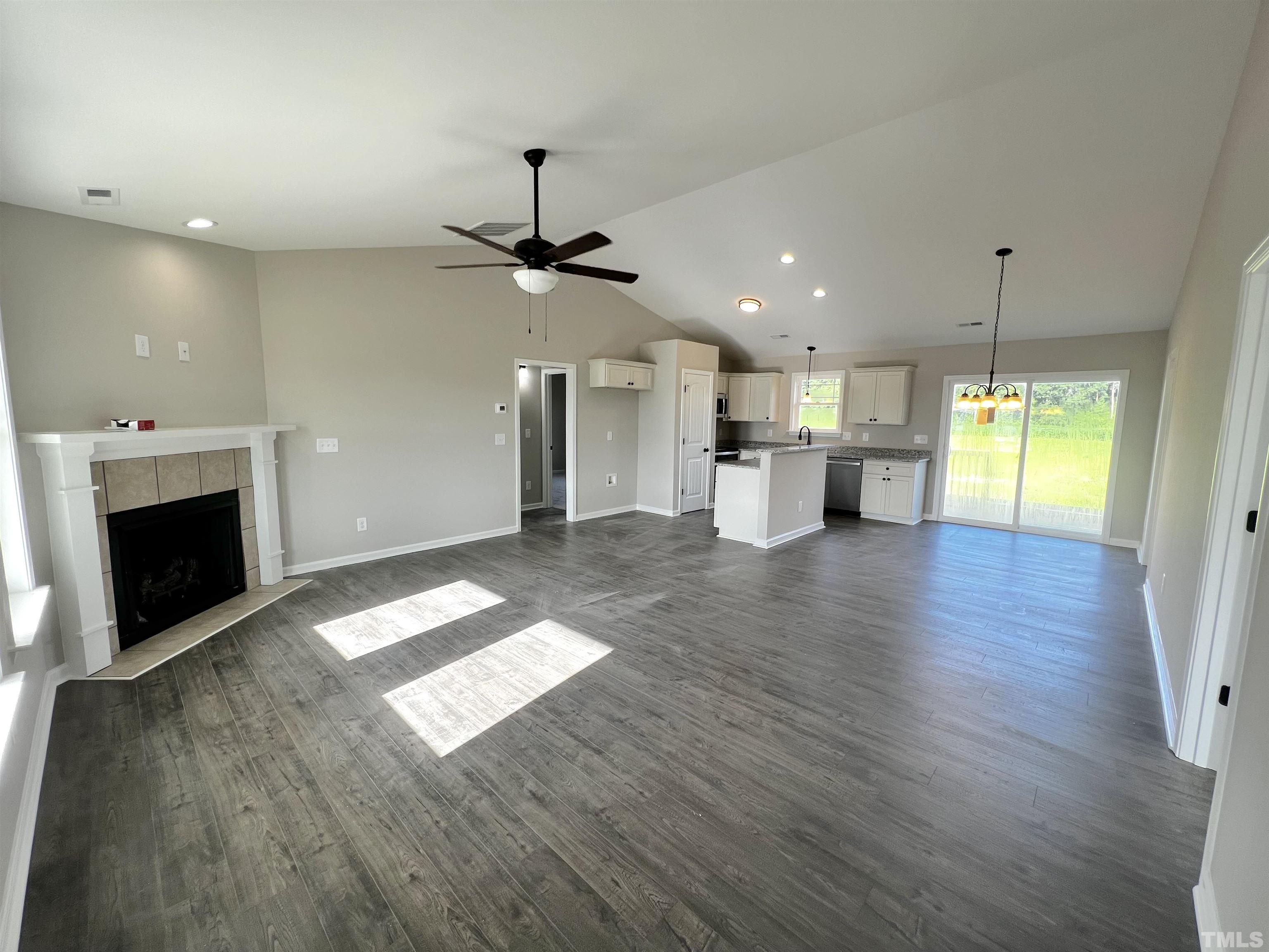 96 Mamie Road Benson, NC 27504 - Photo 4 of 20 a view of an empty room with a fireplace and window