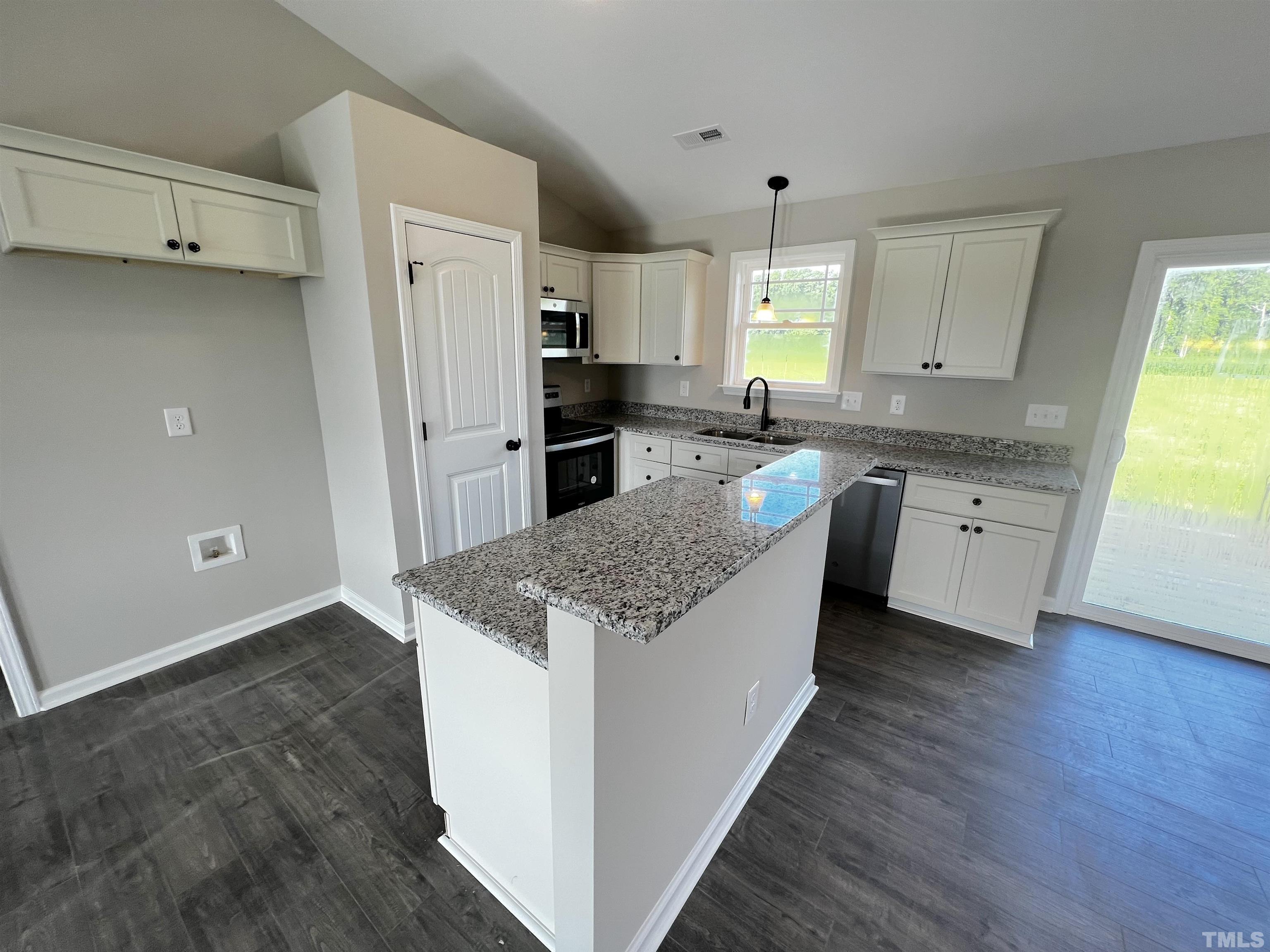 96 Mamie Road Benson, NC 27504 - Photo 6 of 20 a kitchen with granite countertop a sink stove and refrigerator