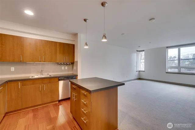 a kitchen that has a sink a stove and window