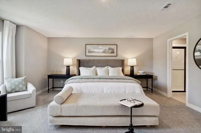 a spacious bedroom with a bed and a couch