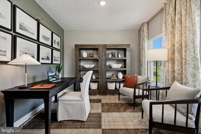 a reading room with furniture wooden floor and a window