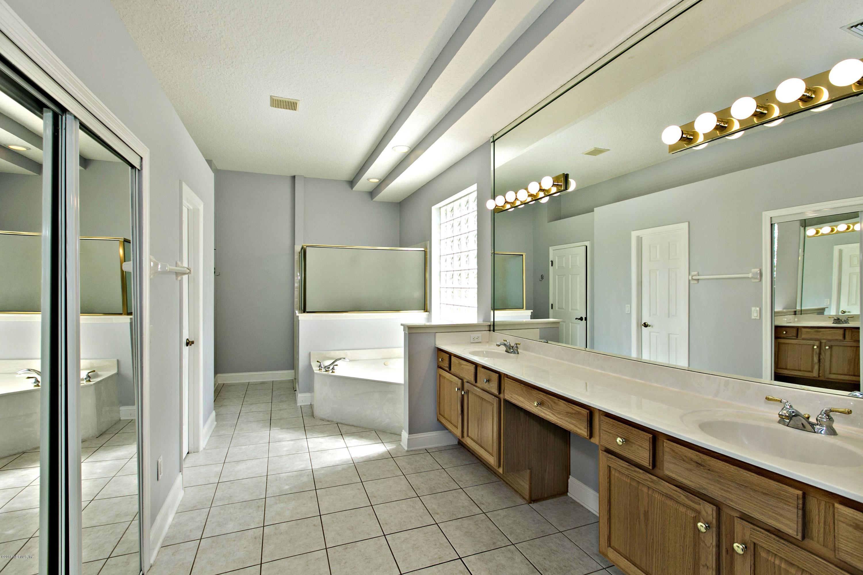 2156 West Quay Road St. Augustine, FL 32092 - Photo 15 of 51 a spacious bathroom with a granite countertop sink a toilet a mirror and shower