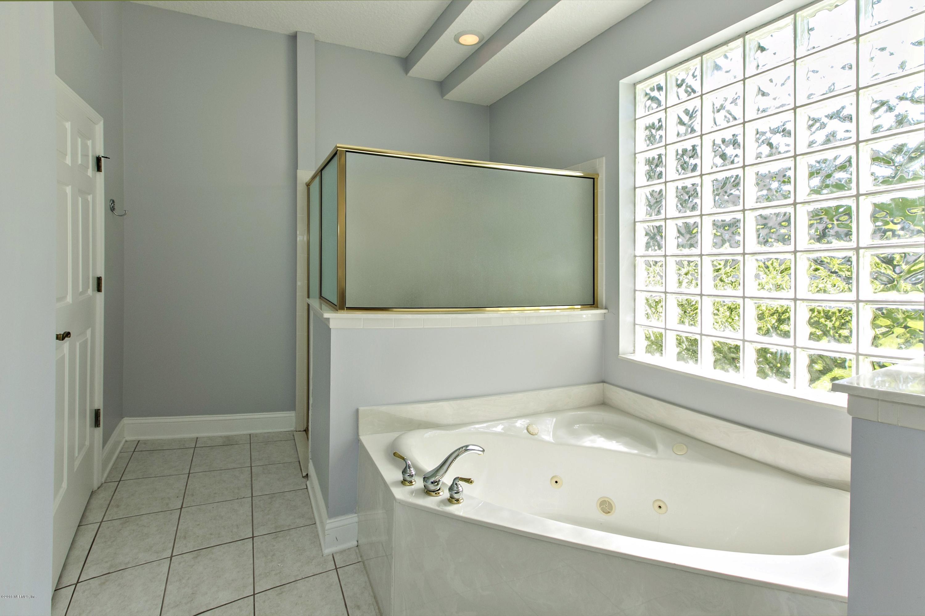 2156 West Quay Road St. Augustine, FL 32092 - Photo 16 of 51 a bathroom with a bathtub and a shower