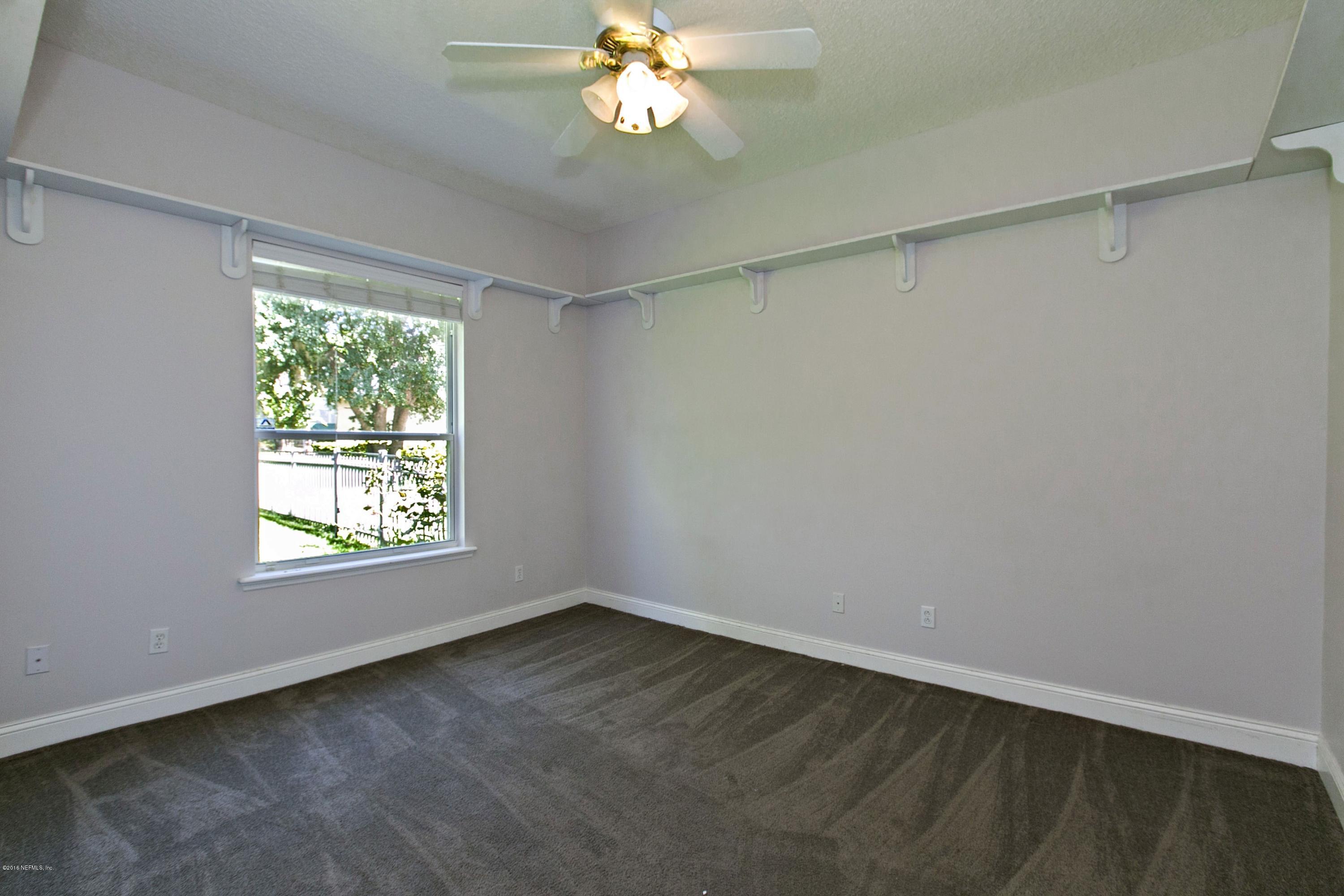 2156 West Quay Road St. Augustine, FL 32092 - Photo 19 of 51 wooden floor in an empty room with a window