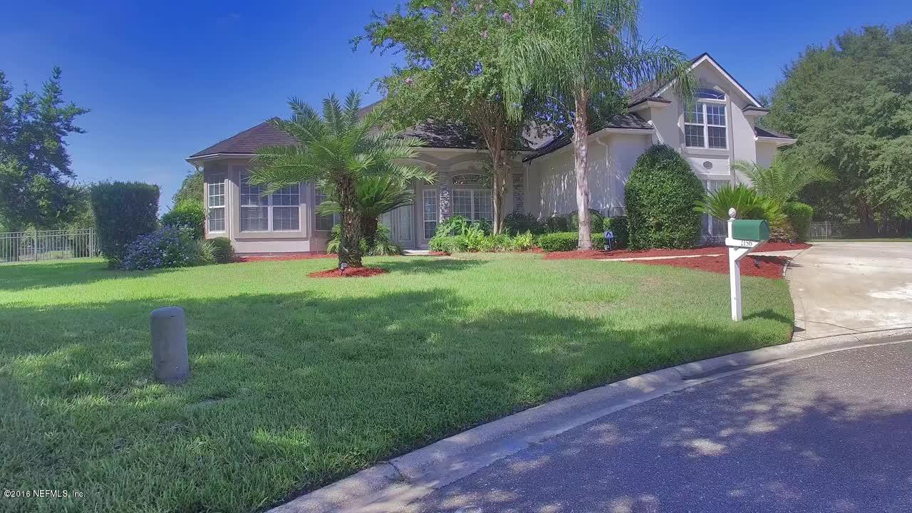 2156 West Quay Road St. Augustine, FL 32092 - Photo 2 of 51 a front view of a house with a yard and garage