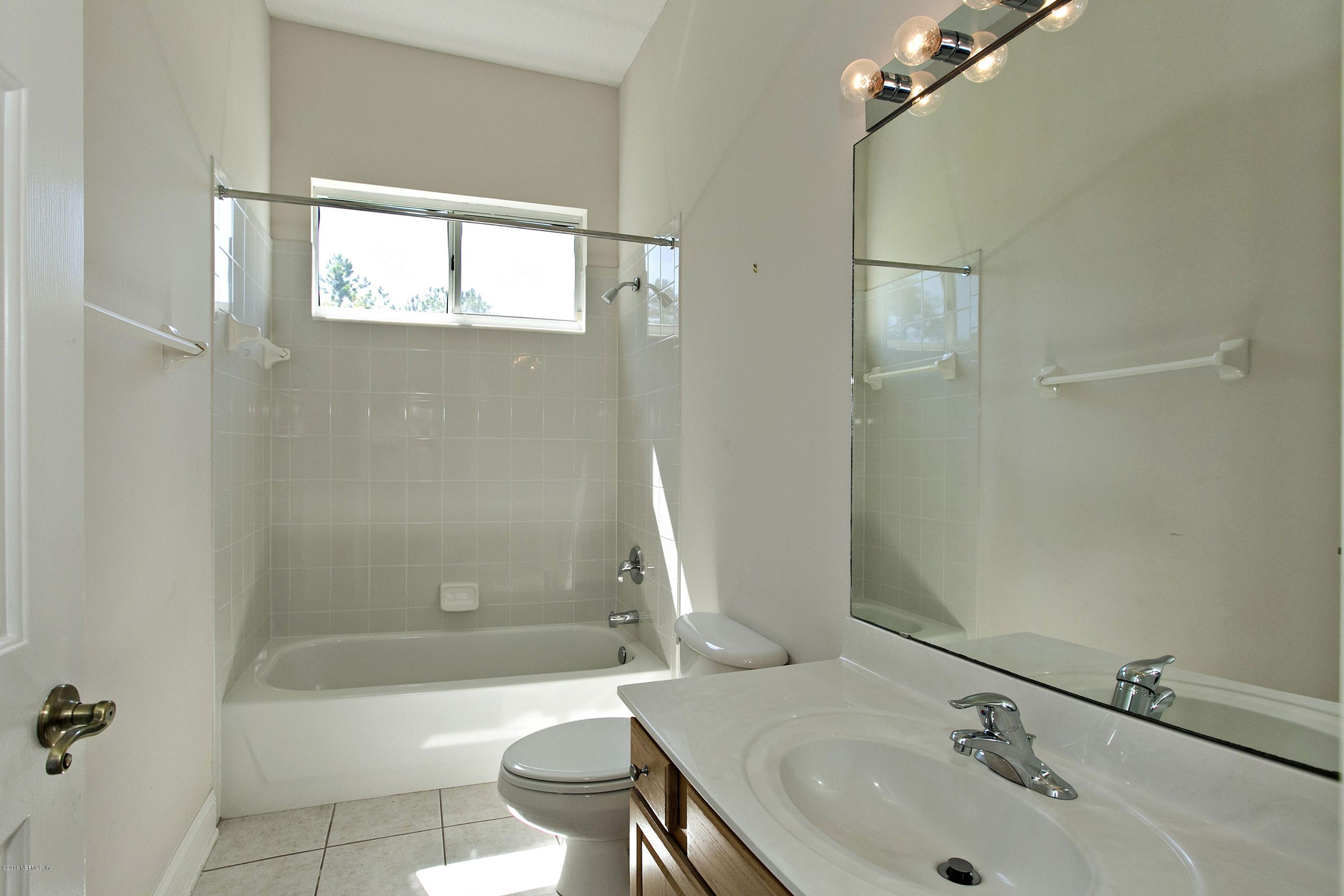 2156 West Quay Road St. Augustine, FL 32092 - Photo 21 of 51 a bathroom with a sink a toilet and shower