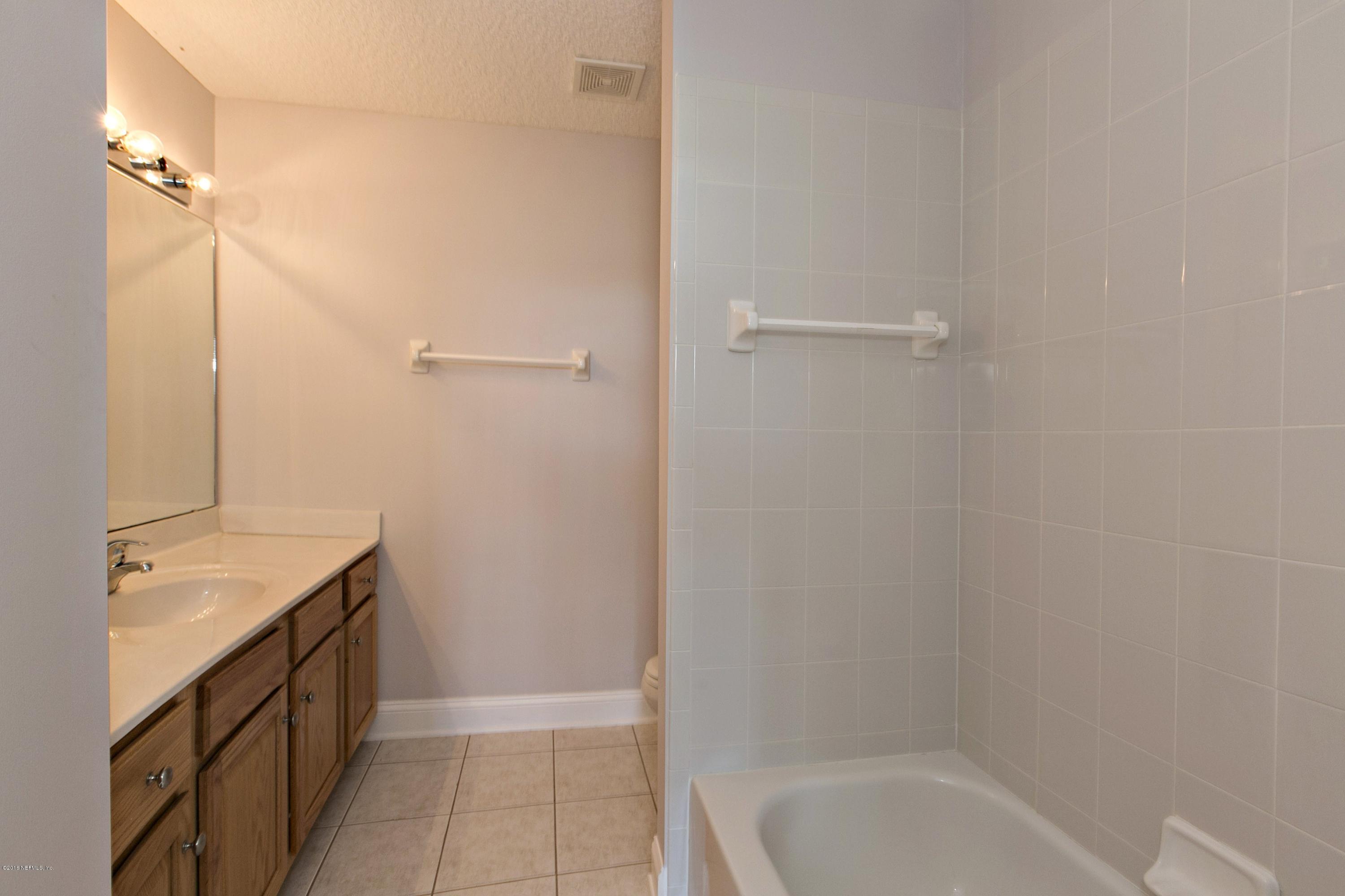 2156 West Quay Road St. Augustine, FL 32092 - Photo 25 of 51 a bathroom with a granite countertop sink a toilet and shower