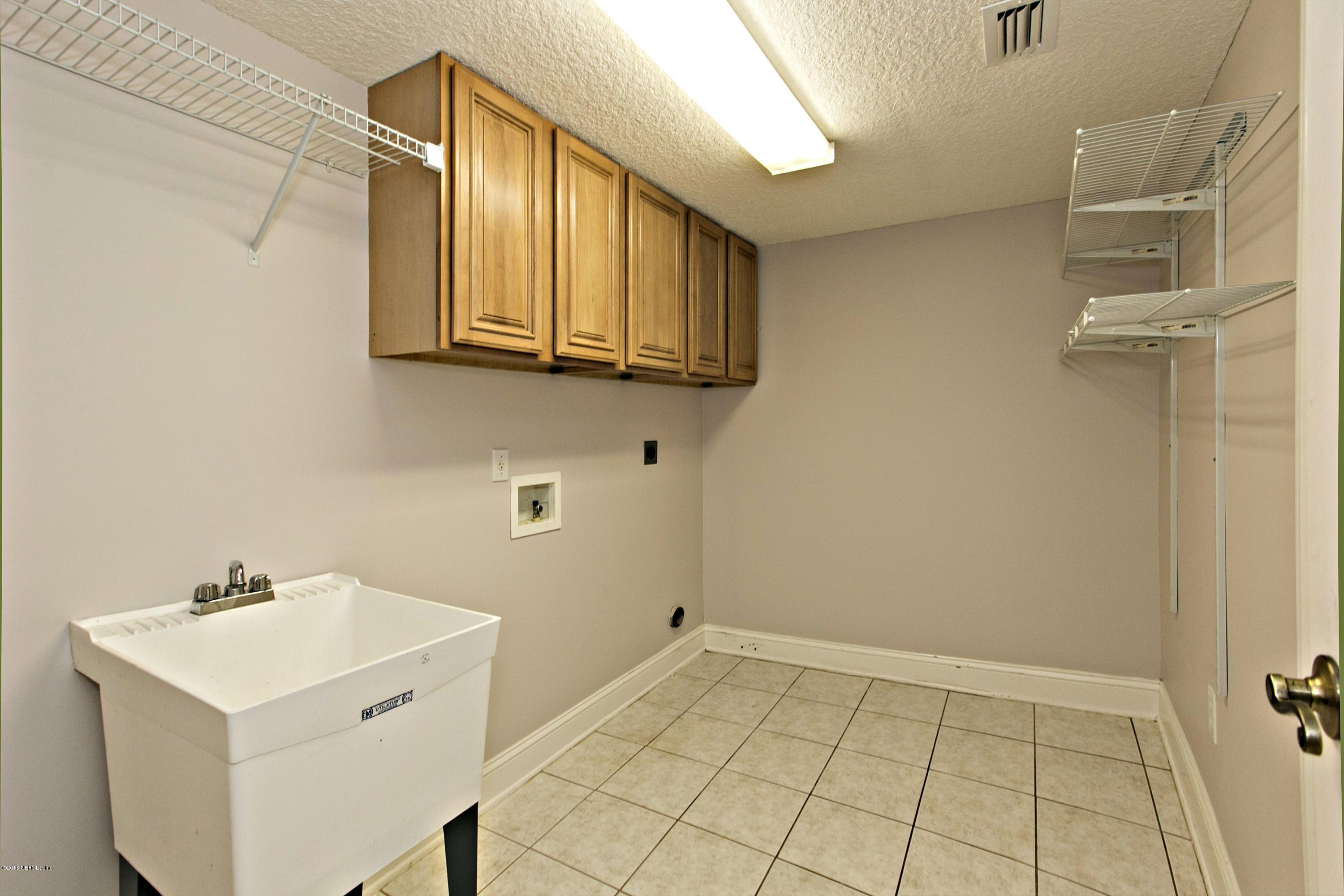 2156 West Quay Road St. Augustine, FL 32092 - Photo 26 of 51 a bathroom with a sink and a mirror