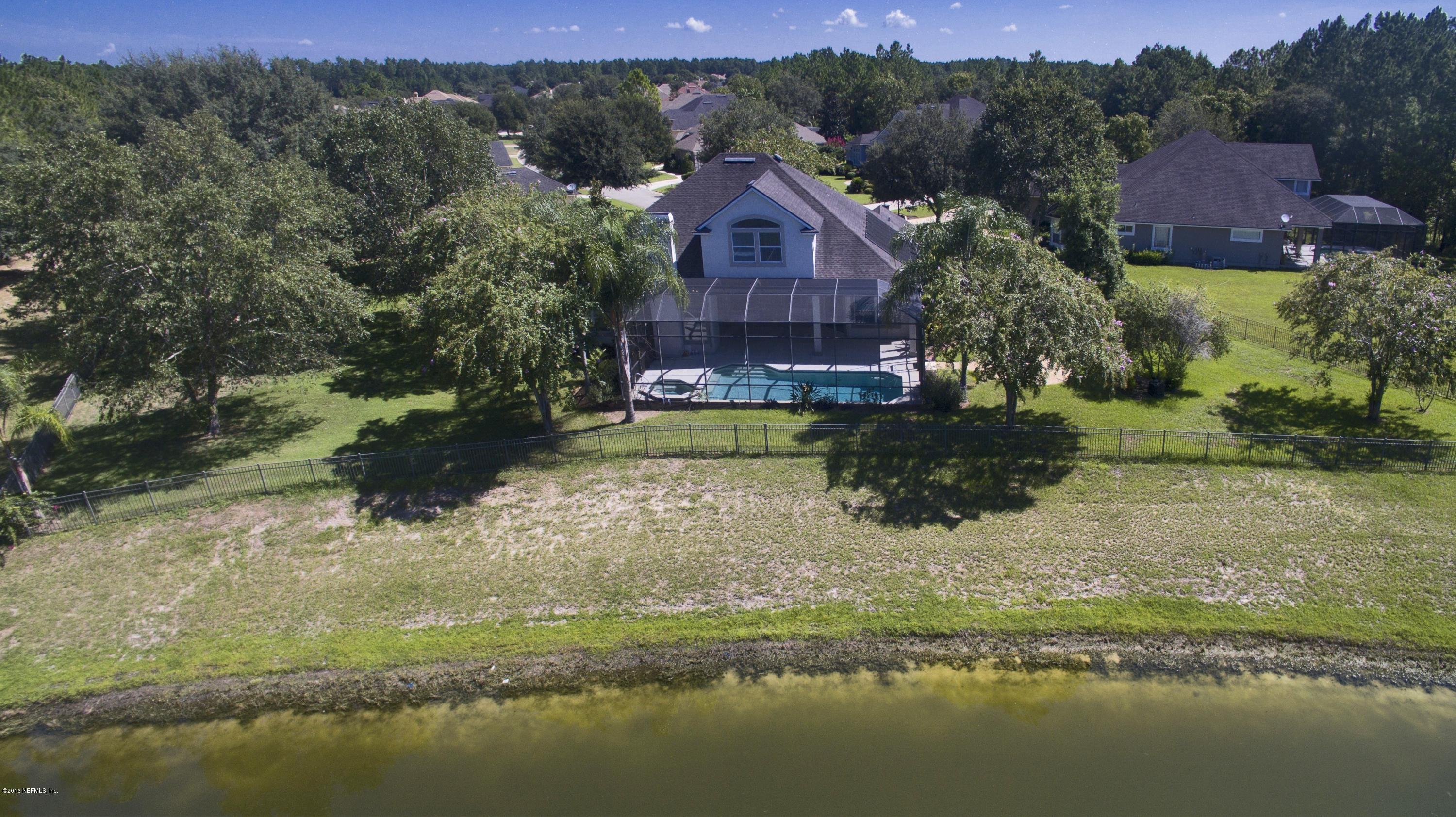 2156 West Quay Road St. Augustine, FL 32092 - Photo 37 of 51 a view of a lake with a house in the background