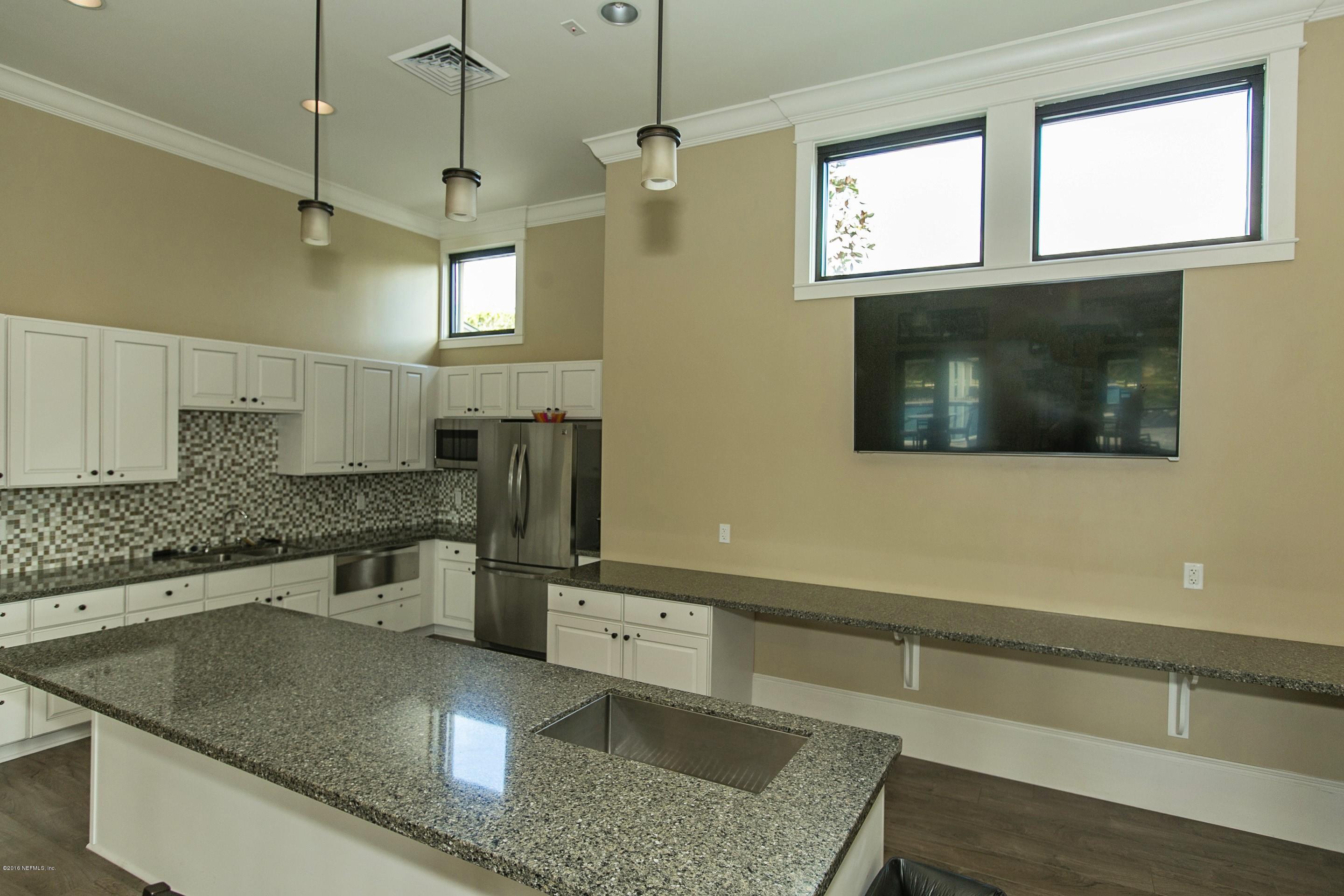 2156 West Quay Road St. Augustine, FL 32092 - Photo 47 of 51 a kitchen with stainless steel appliances granite countertop a sink a microwave a stove and a refrigerator
