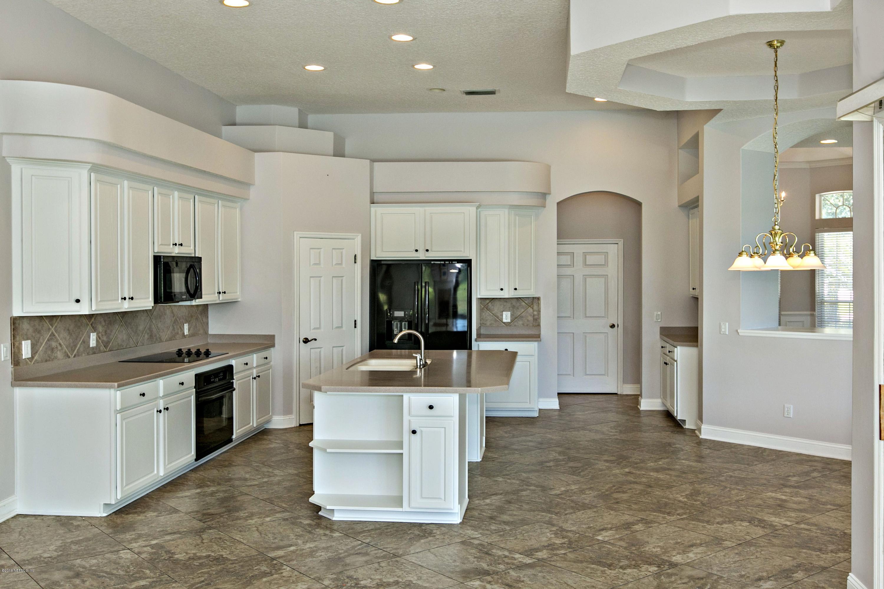 2156 West Quay Road St. Augustine, FL 32092 - Photo 9 of 51 a large kitchen with stainless steel appliances kitchen island granite countertop a stove and a sink
