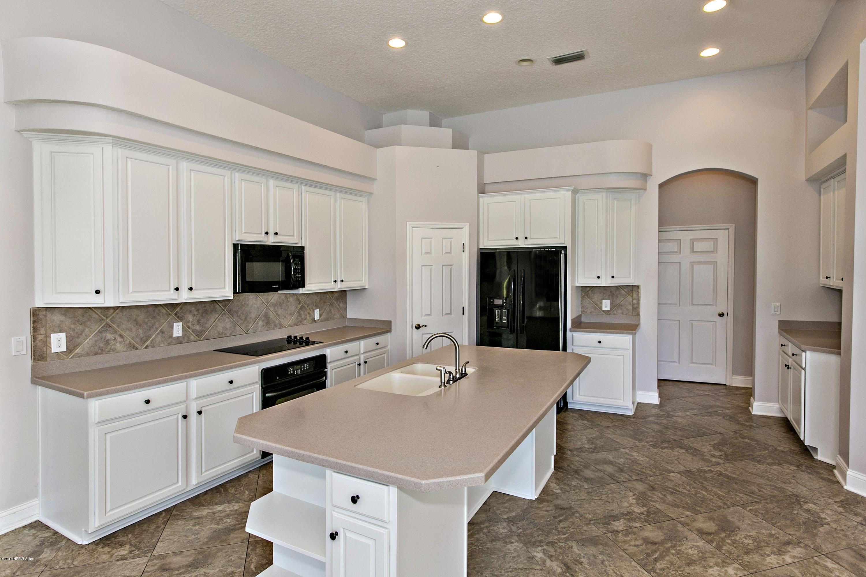 2156 West Quay Road St. Augustine, FL 32092 - Photo 10 of 51 a kitchen with white cabinets and stainless steel appliances