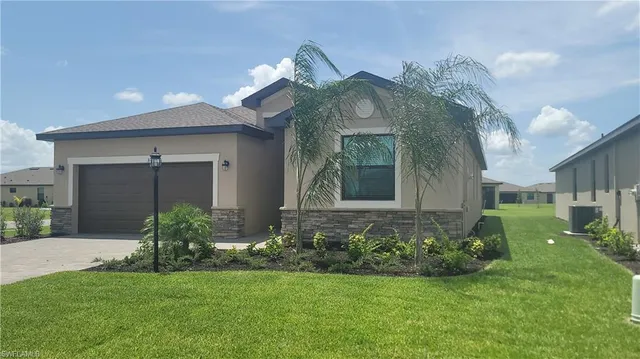 a view of a house with a small yard and plants