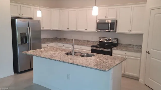 a bathroom with a granite countertop sink and mirror