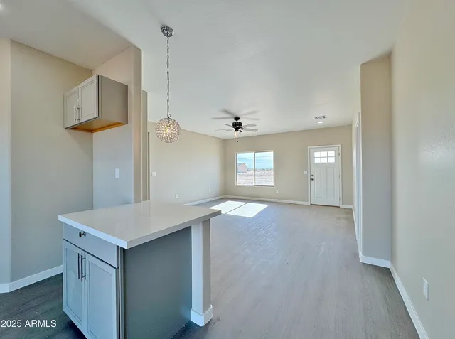 a view of an empty room and window and cabinet