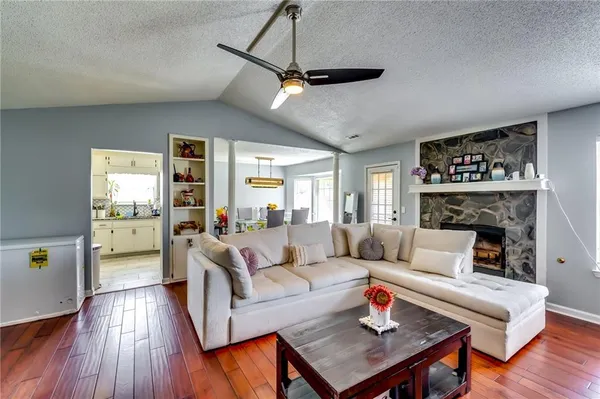a living room with furniture and a fireplace