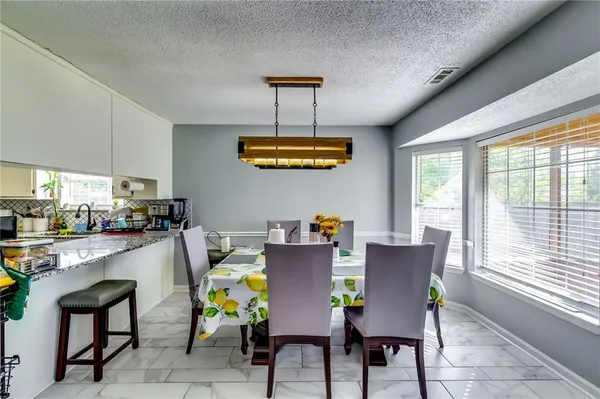 a dining room with furniture and window