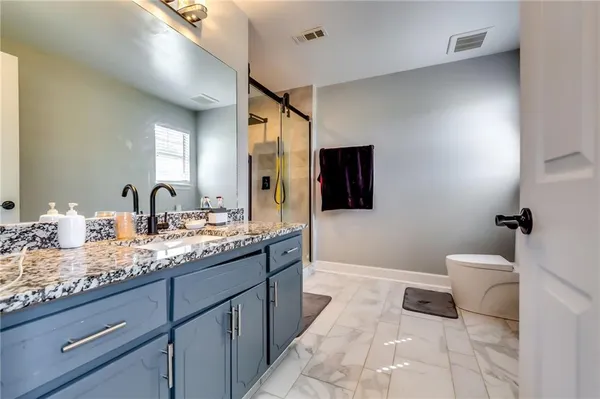 a spacious bathroom with a double vanity sink and a mirror