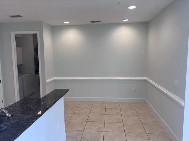 a view of a kitchen with white cabinets