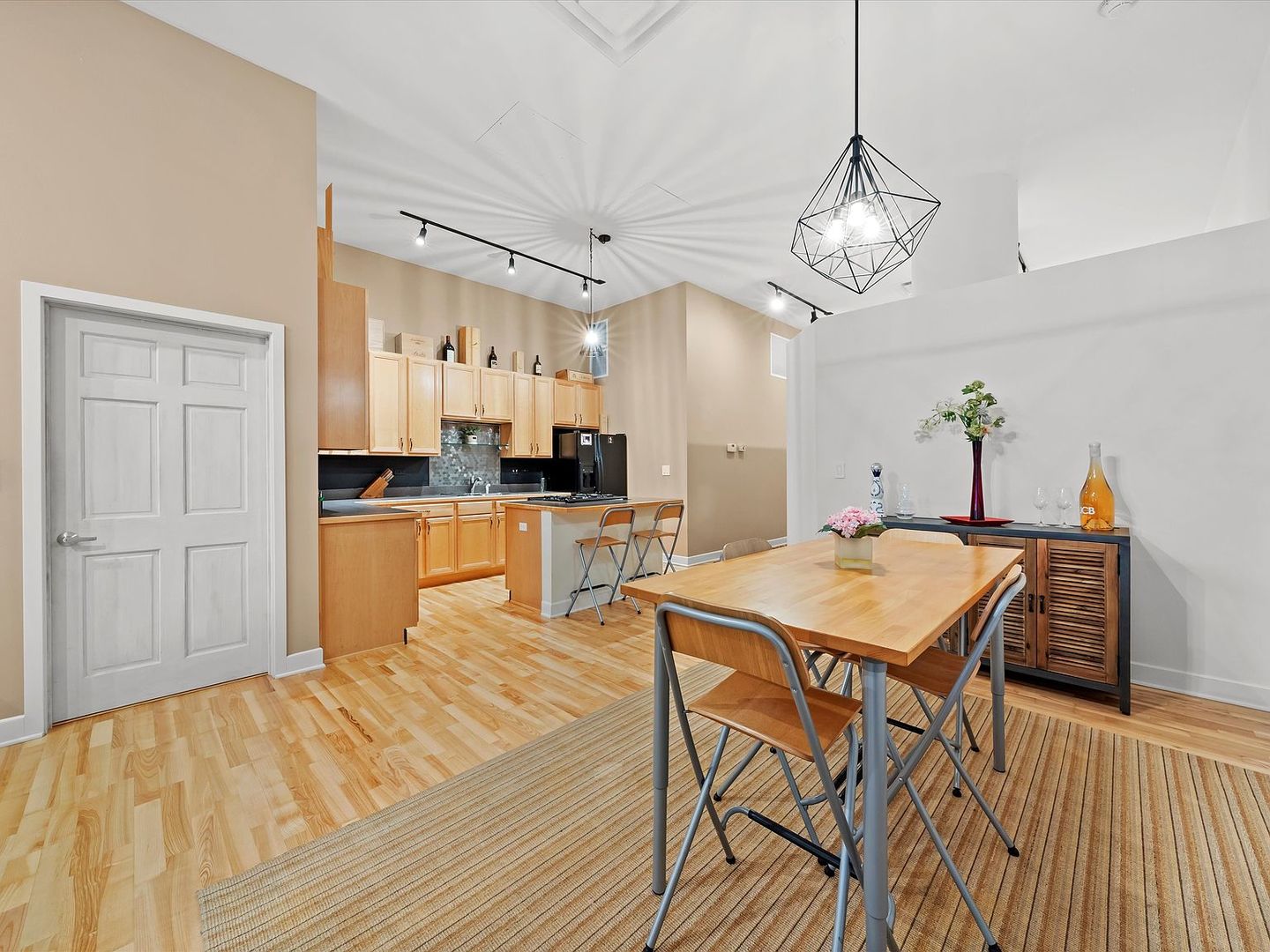 211 East Ohio Street, Unit 307 Chicago, IL 60611 - Photo 6 of 30 a kitchen with stainless steel appliances kitchen island granite countertop a table chairs and a refrigerator