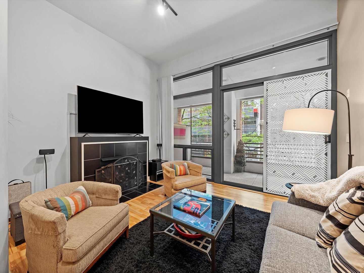 211 East Ohio Street, Unit 307 Chicago, IL 60611 - Photo 7 of 30 a living room with furniture a flat screen tv and a fireplace