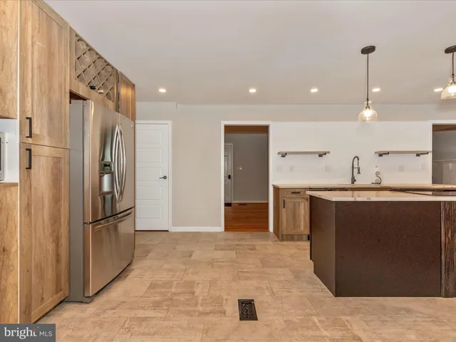 a kitchen with stainless steel appliances granite countertop a refrigerator and a sink