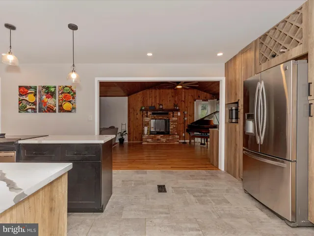 a kitchen with a sink window and stainless steel appliances