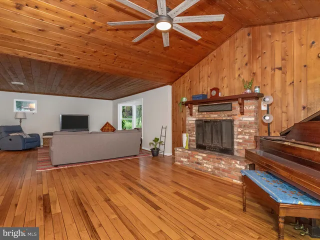 a view of a room with wooden floor