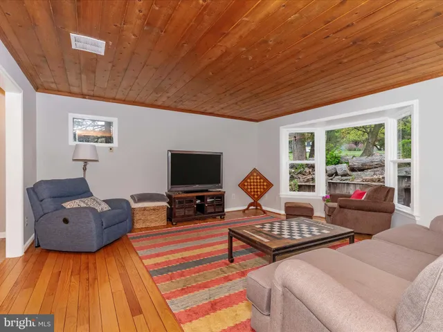 a living room with furniture a rug and a window